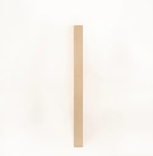 A modern wall plaque that reads “Comfort Is the Enemy of Growth” in bold, minimalist black letters on a clean woodgrain background.