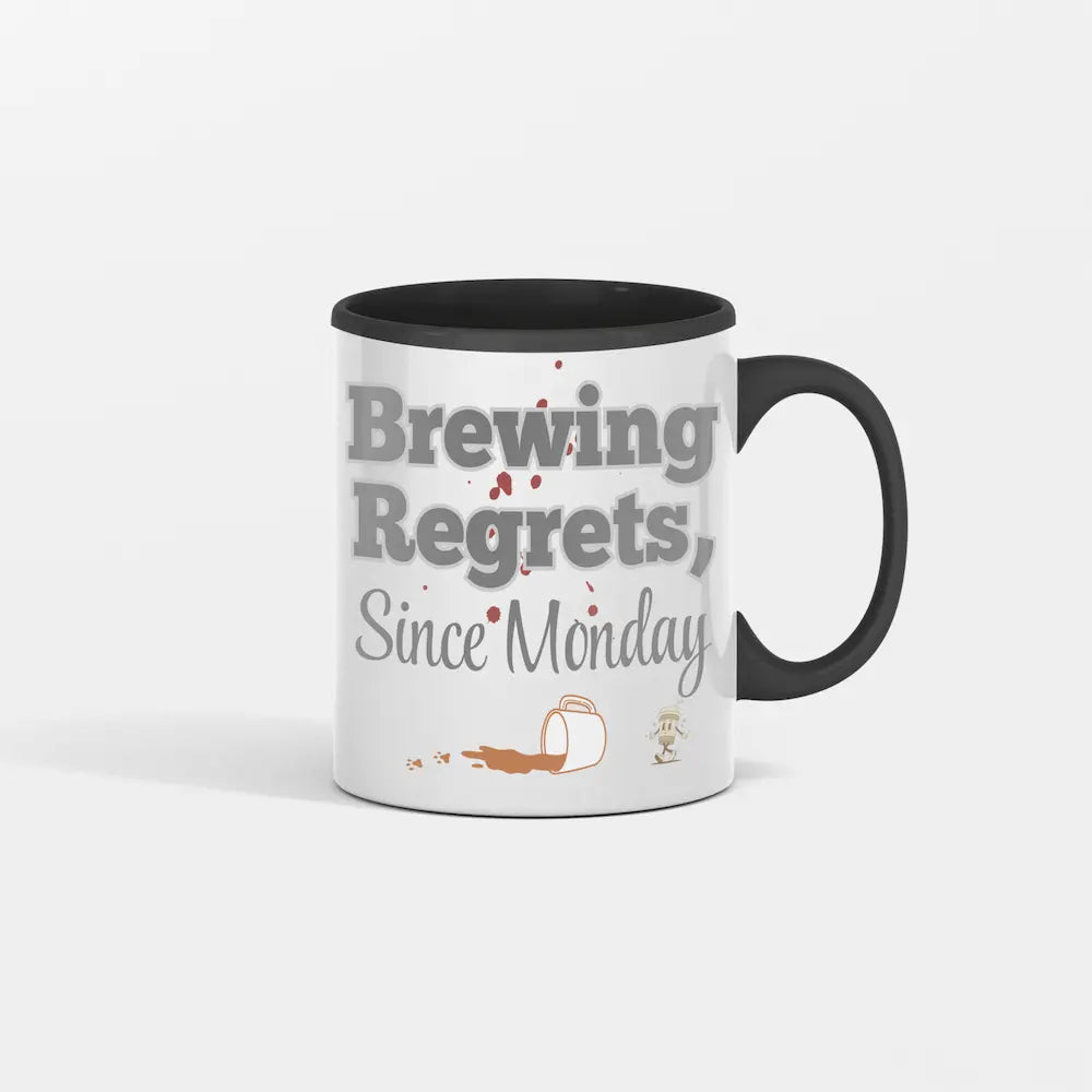 White ceramic mug with bold black text: “Brew Regrets Since Monday” and spilled coffee stain detail on background.