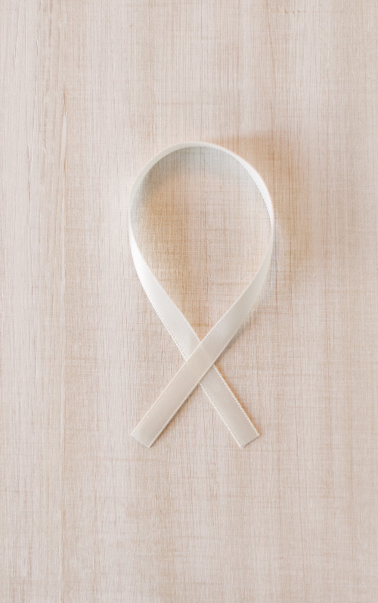Colorful ribbon ornament with “HOPE, LOVE, CURE” text, supporting pediatric cancer awareness and research fundraising.