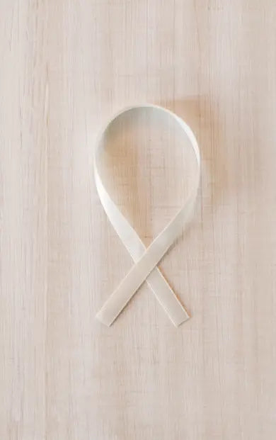 Colorful ribbon ornament with “HOPE, LOVE, CURE” text, supporting pediatric cancer awareness and research fundraising.