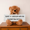 A teddy bear sitting on a wooden surface holding a sign with the phrase 'WHAT IF SARCASM HAD AN EXPIRATION DATE?'