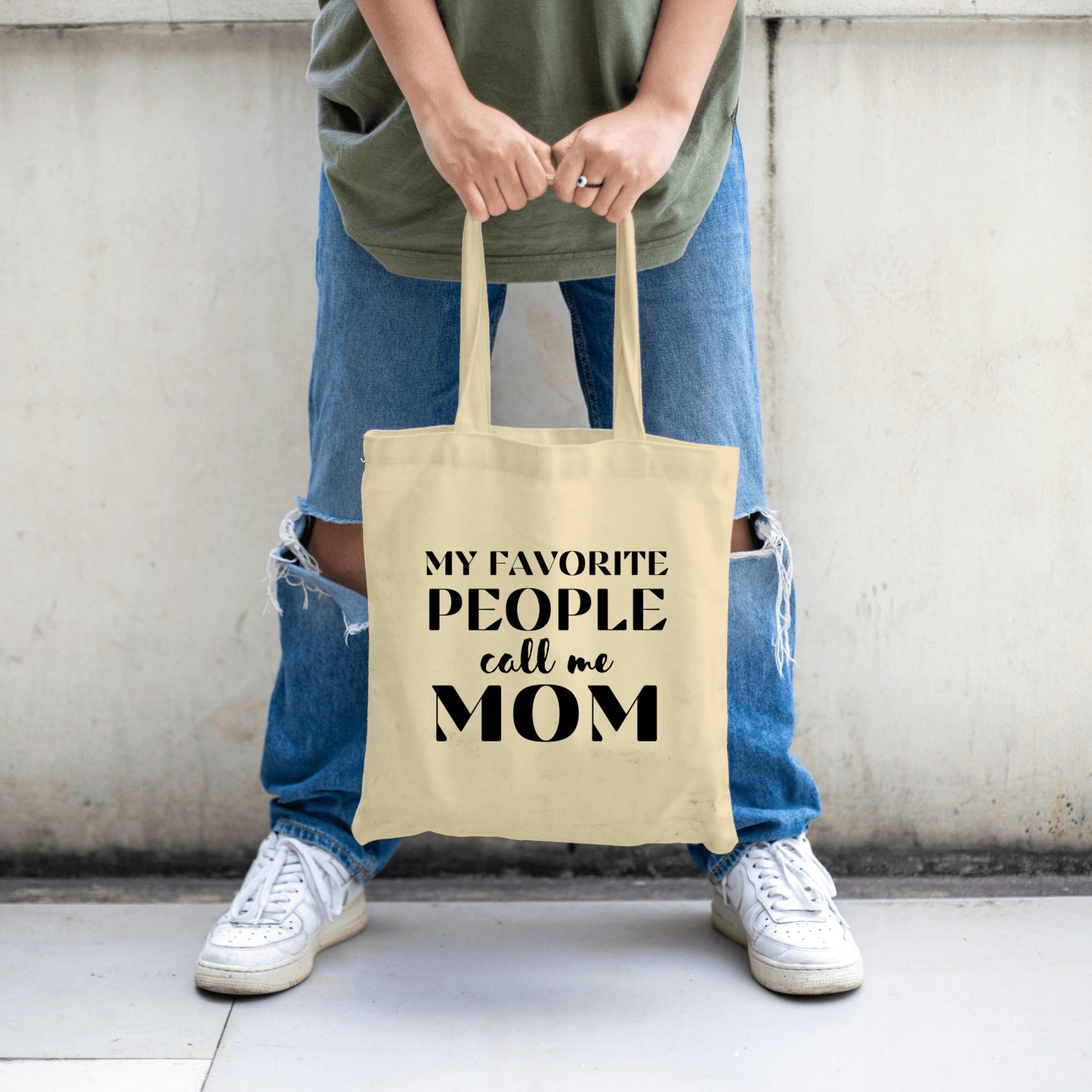 "Canvas tote bag with the phrase 'My Favorite People Call Me Mom' printed in stylish script, ideal for daily use or gifting to moms."

