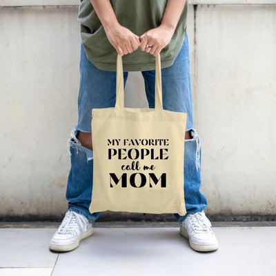 "Canvas tote bag with the phrase 'My Favorite People Call Me Mom' printed in stylish script, ideal for daily use or gifting to moms."

