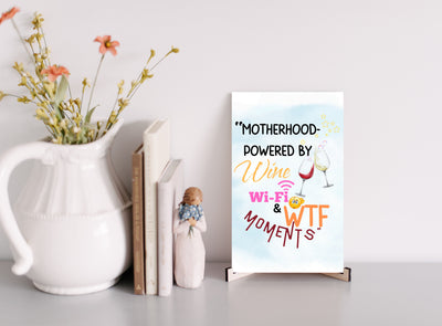 Mother’s Day hanging plaque – “Motherhood Powered By Win, WiFi, & WTF Moments” funny wall décor for moms.