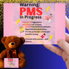 Bold comic-style PMS warning card with a pink storm background, cartoon icons like thunderclouds, chocolate bars, and explosive emojis, delivering a humorous and edgy message.