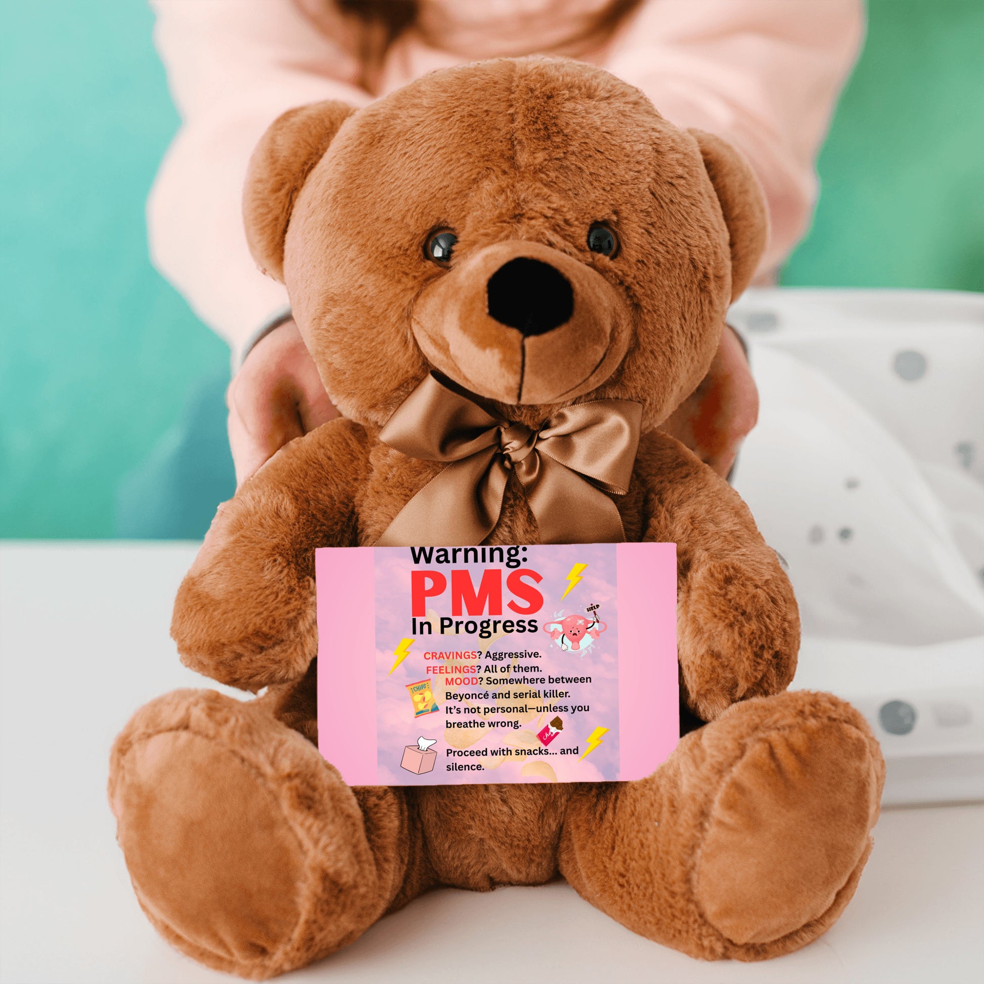Bold comic-style PMS warning card with a pink storm background, cartoon icons like thunderclouds, chocolate bars, and explosive emojis, delivering a humorous and edgy message.