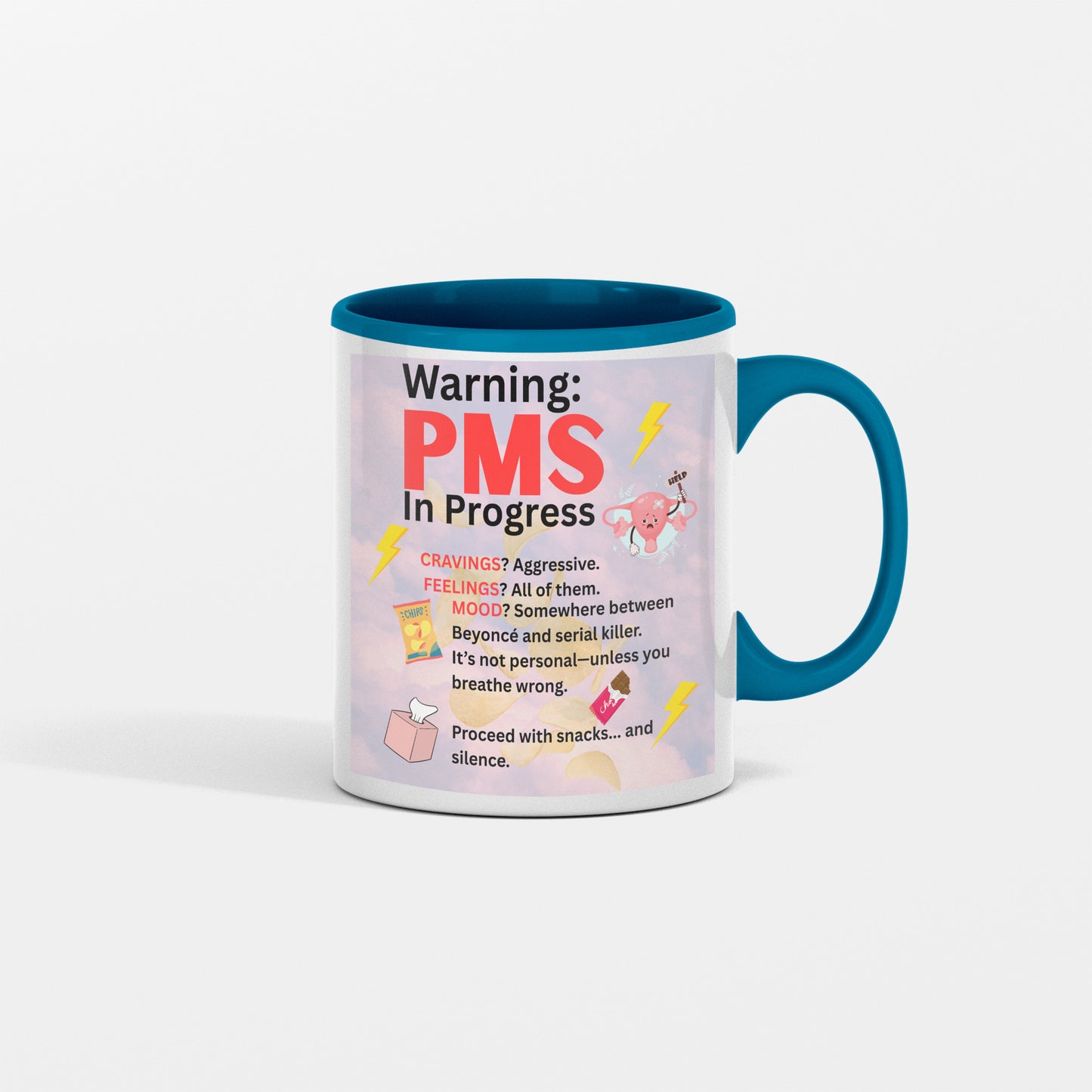 White ceramic coffee mug with bold text reading “PMS IN PROGRESS – Proceed at Your Own Risk” in a fun, comic-style font – perfect for women’s humor gifts.

