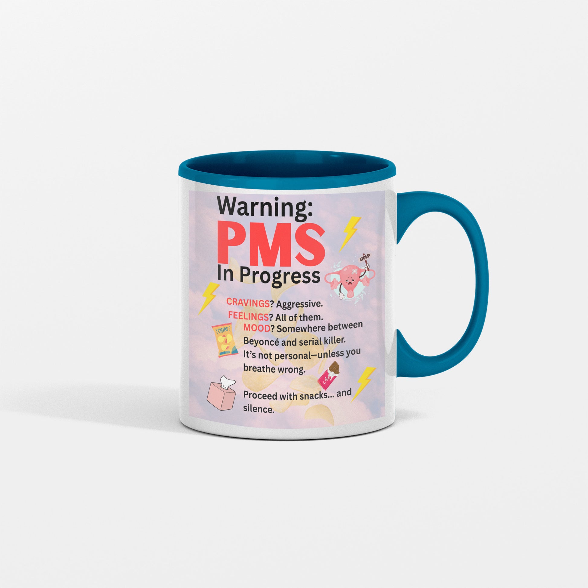 White ceramic coffee mug with bold text reading “PMS IN PROGRESS – Proceed at Your Own Risk” in a fun, comic-style font – perfect for women’s humor gifts.

