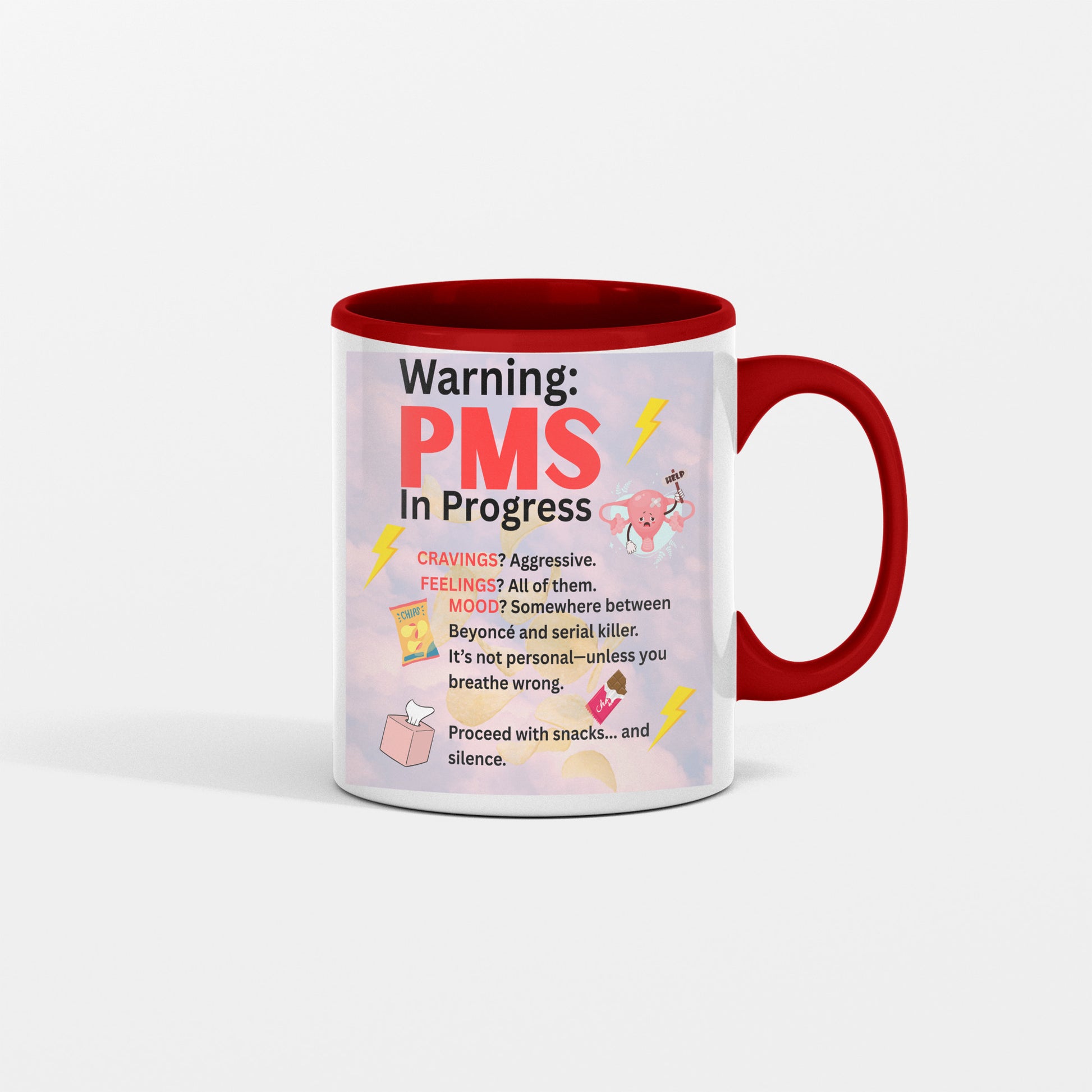 White ceramic coffee mug with bold text reading “PMS IN PROGRESS – Proceed at Your Own Risk” in a fun, comic-style font – perfect for women’s humor gifts.