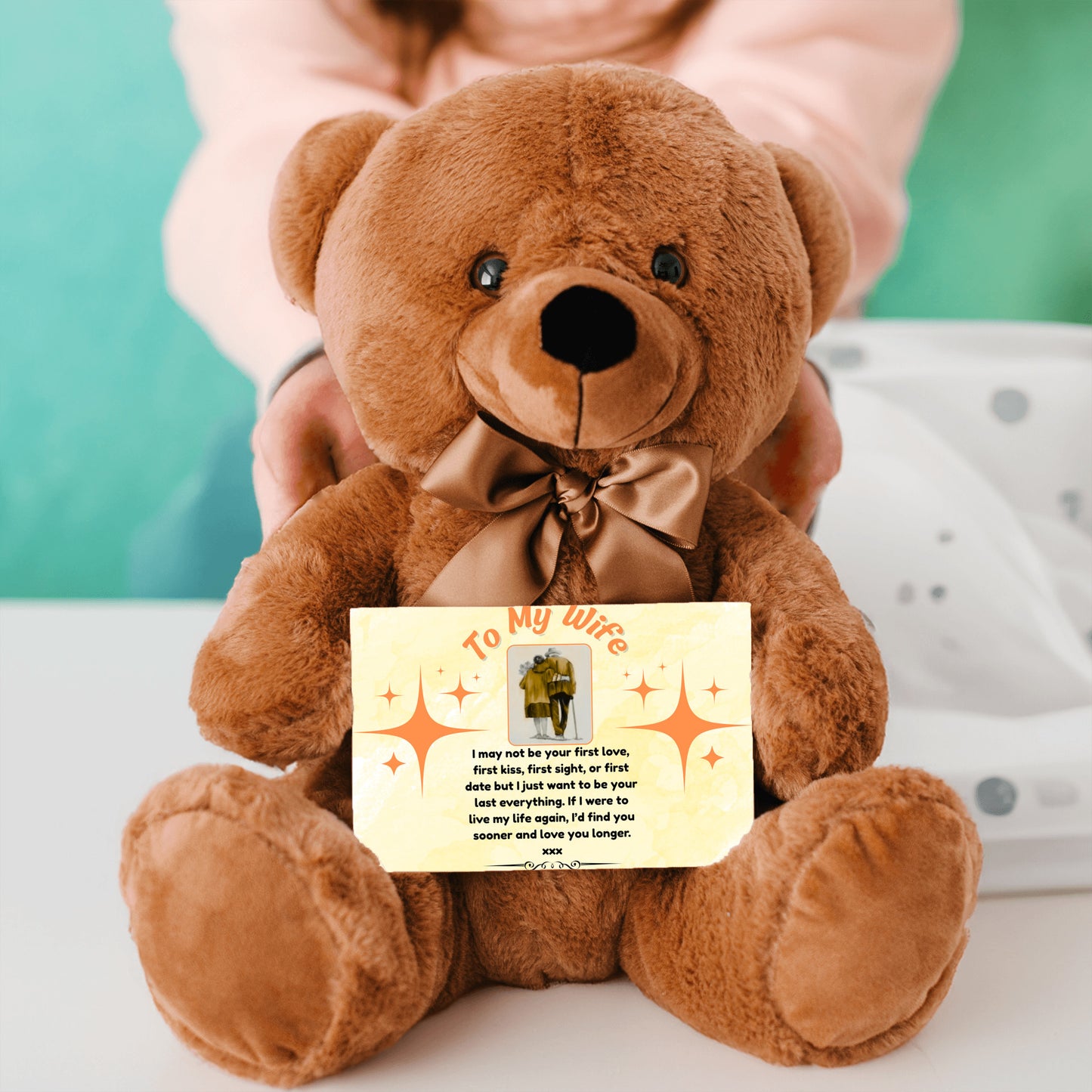“Adorable plush teddy bear holding a heartfelt message card that reads ‘To My Wife’, designed as a sentimental gift for anniversaries, birthdays, or just because. Perfect for expressing love and appreciation.”