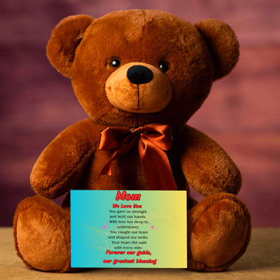 "Plush teddy bear holding a card with the message 'Mom, We Love You – Forever Our Guide' on a pink floral background."