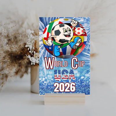 Bold graphic design featuring “WORLD CUP USA 2026” in patriotic red, white, and blue with a humorous or high-energy soccer theme.

