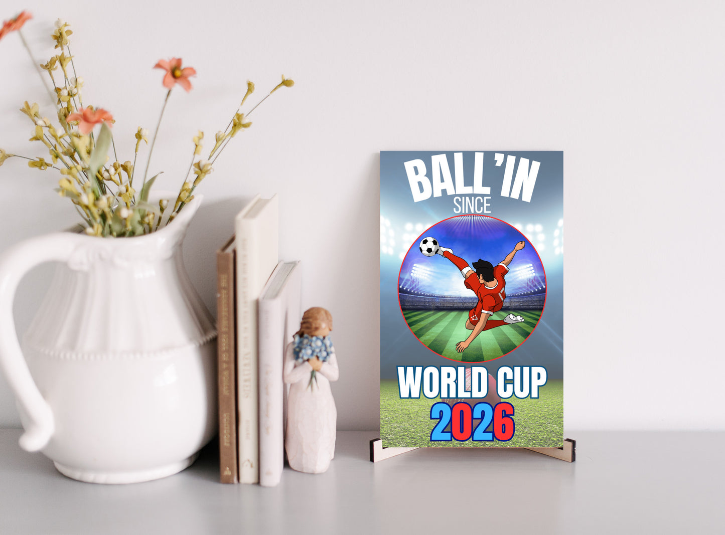 A humorous design with bold text reading “BALL’IN SINCE WORLD CUP 2026,” styled in athletic lettering and a sporty, sarcastic theme.