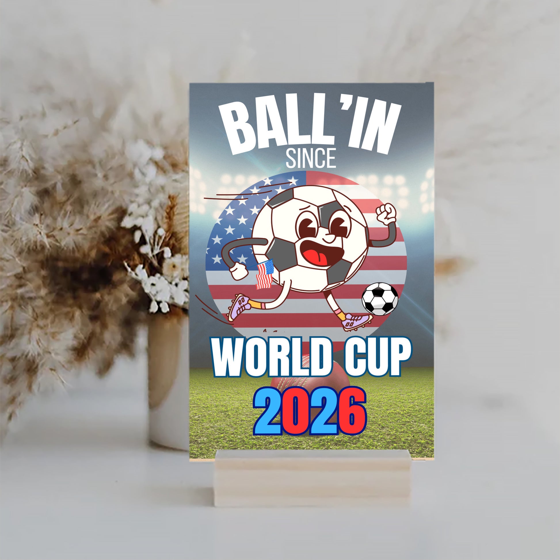 A humorous design with bold text reading “BALL’IN SINCE WORLD CUP 2026,” styled in athletic lettering and a sporty, sarcastic theme.