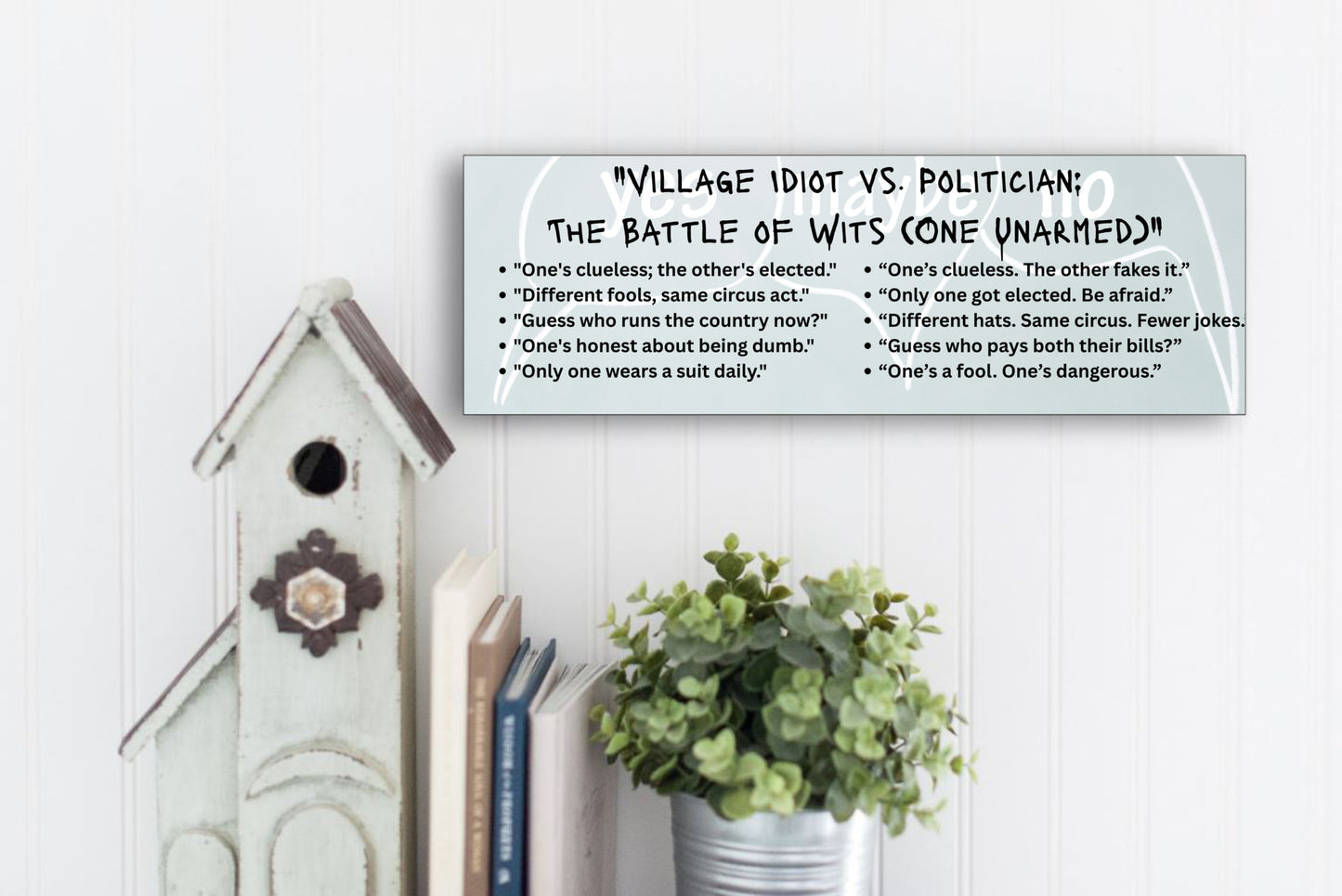 A comic-style plaque titled "Village Idiot vs. Politician," featuring caricatures of a confused jester and a smug politician, highlighting their shared talent for causing chaos.