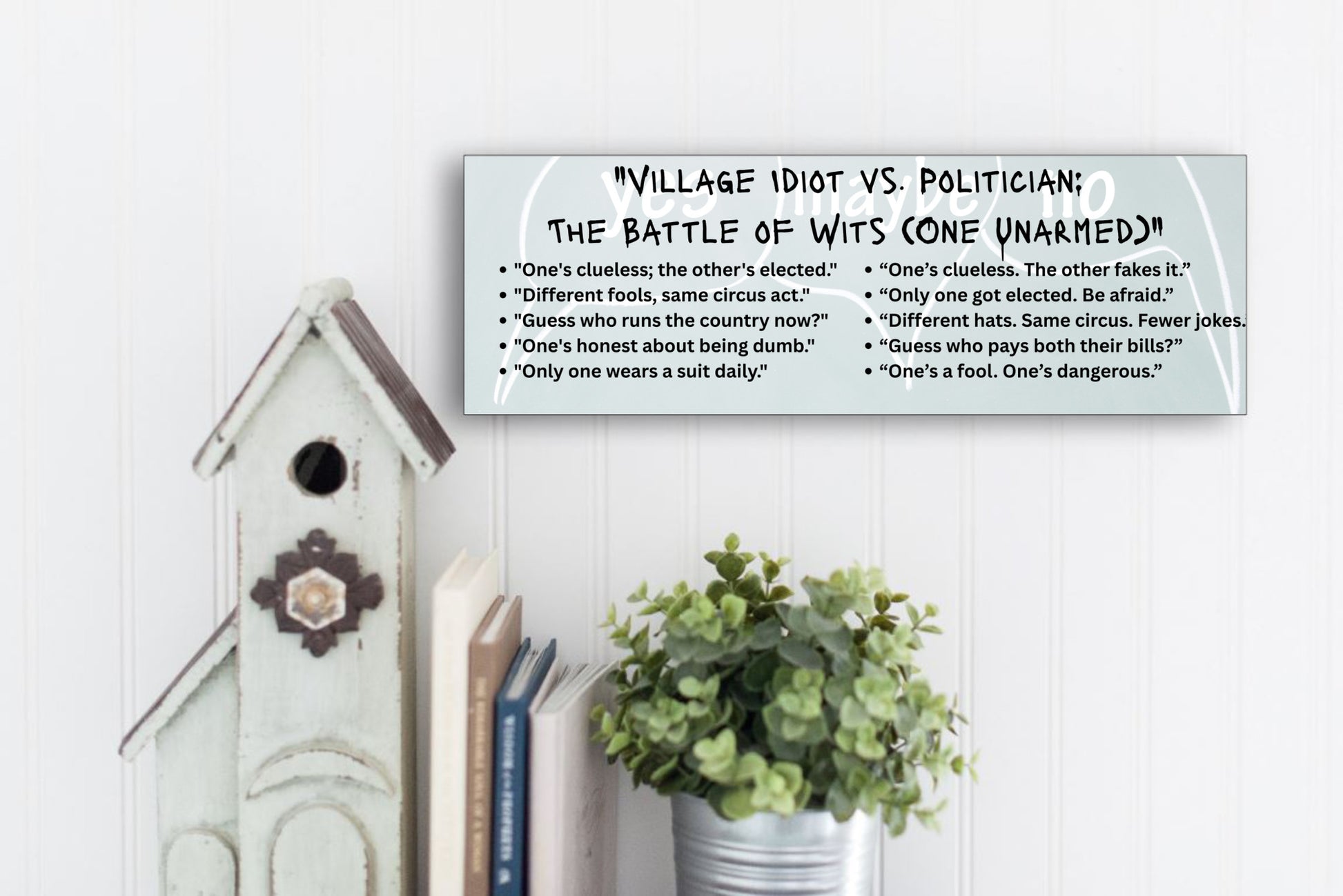 A comic-style plaque titled "Village Idiot vs. Politician," featuring caricatures of a confused jester and a smug politician, highlighting their shared talent for causing chaos.