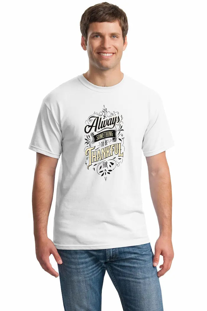 Person wearing the Gratitude T-Shirt, bold text reading “Always Something Thankful For,” casual urban background.