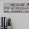Funny bartender plaque that reads “Dear Customers: The Tip Jar Is Not Just a Decoration”