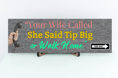 Funny bartender plaque that reads “Your Wife Called. She Said Tip Big or Walk Home” in bold neon letters.