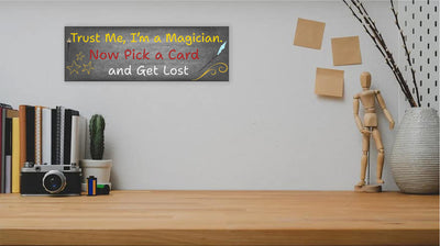 Sarcastic magician-themed plaque with the quote “Trust Me, I’m a Magician – Now Pick a Card and Get Lost” in vintage typeface on a bold backdrop.