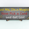 Sarcastic magician-themed plaque with the quote “Trust Me, I’m a Magician – Now Pick a Card and Get Lost” in vintage typeface on a bold backdrop.