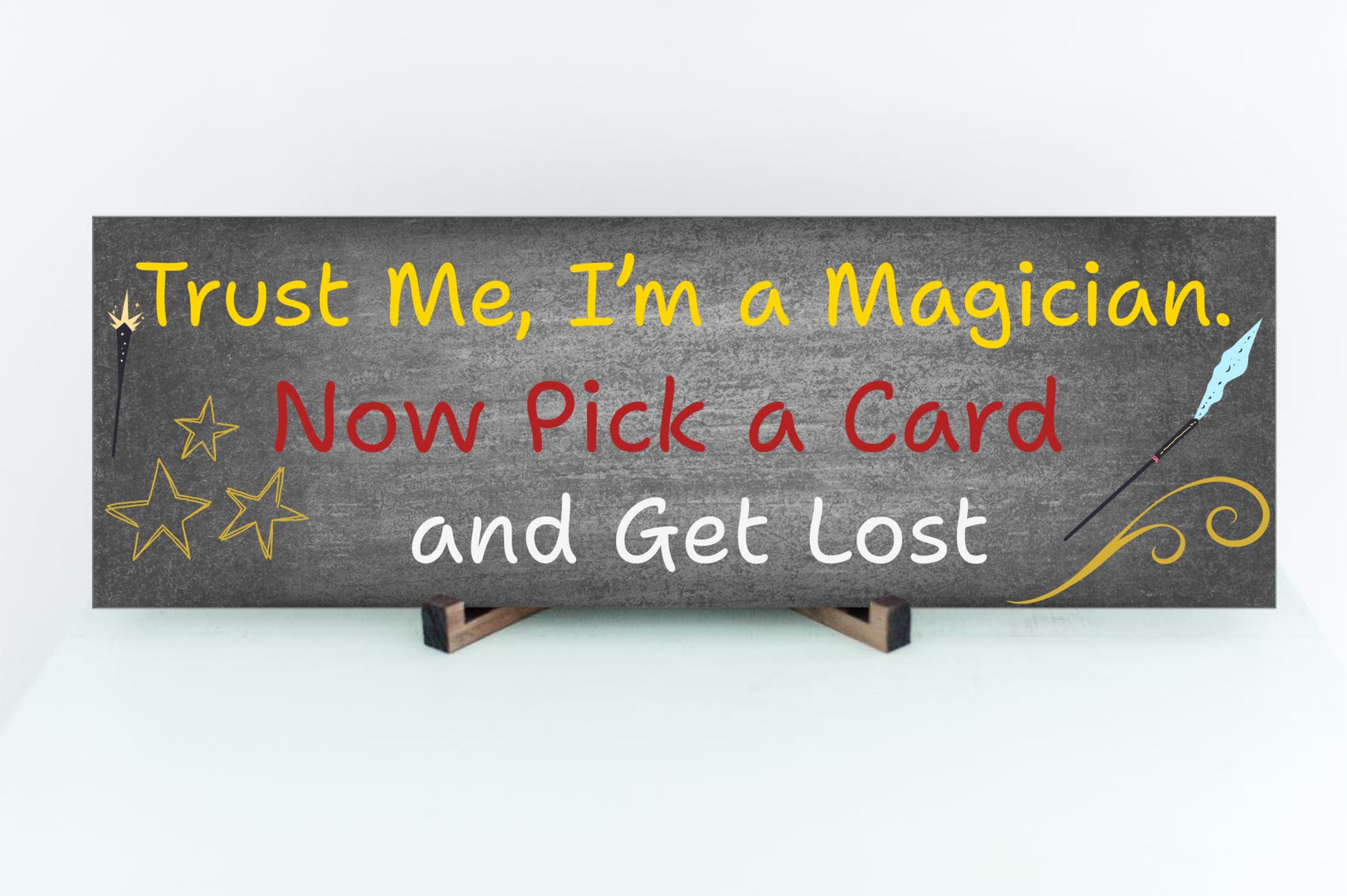 Sarcastic magician-themed plaque with the quote “Trust Me, I’m a Magician – Now Pick a Card and Get Lost” in vintage typeface on a bold backdrop.