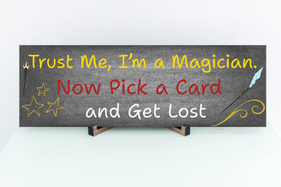 Sarcastic magician-themed plaque with the quote “Trust Me, I’m a Magician – Now Pick a Card and Get Lost” in vintage typeface on a bold backdrop.