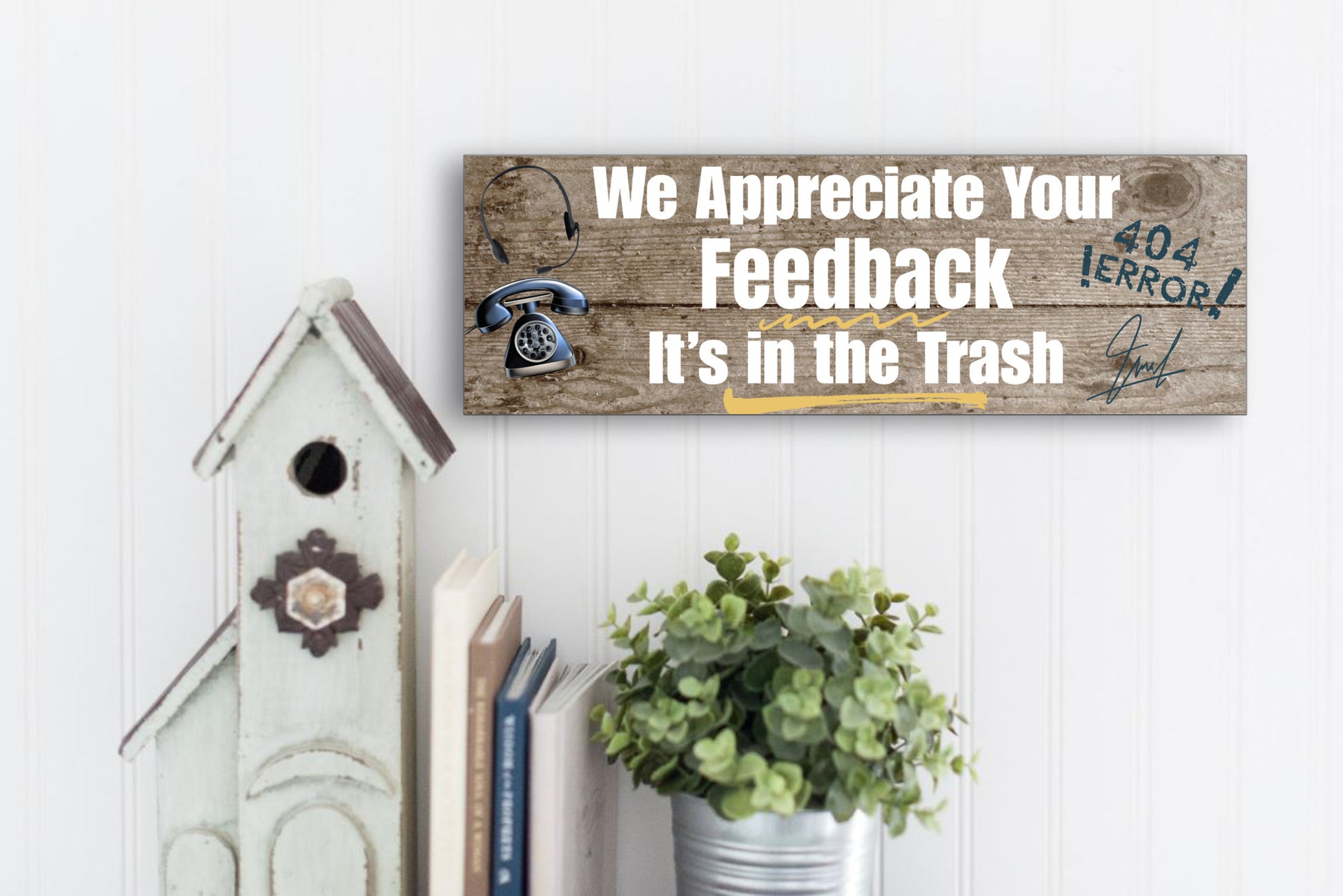 A rectangular wooden plaque featuring the sarcastic phrase "We Appreciate Your Feedback – It’s in the Trash" in bold white and red text on a dark vintage background with ornamental border details.