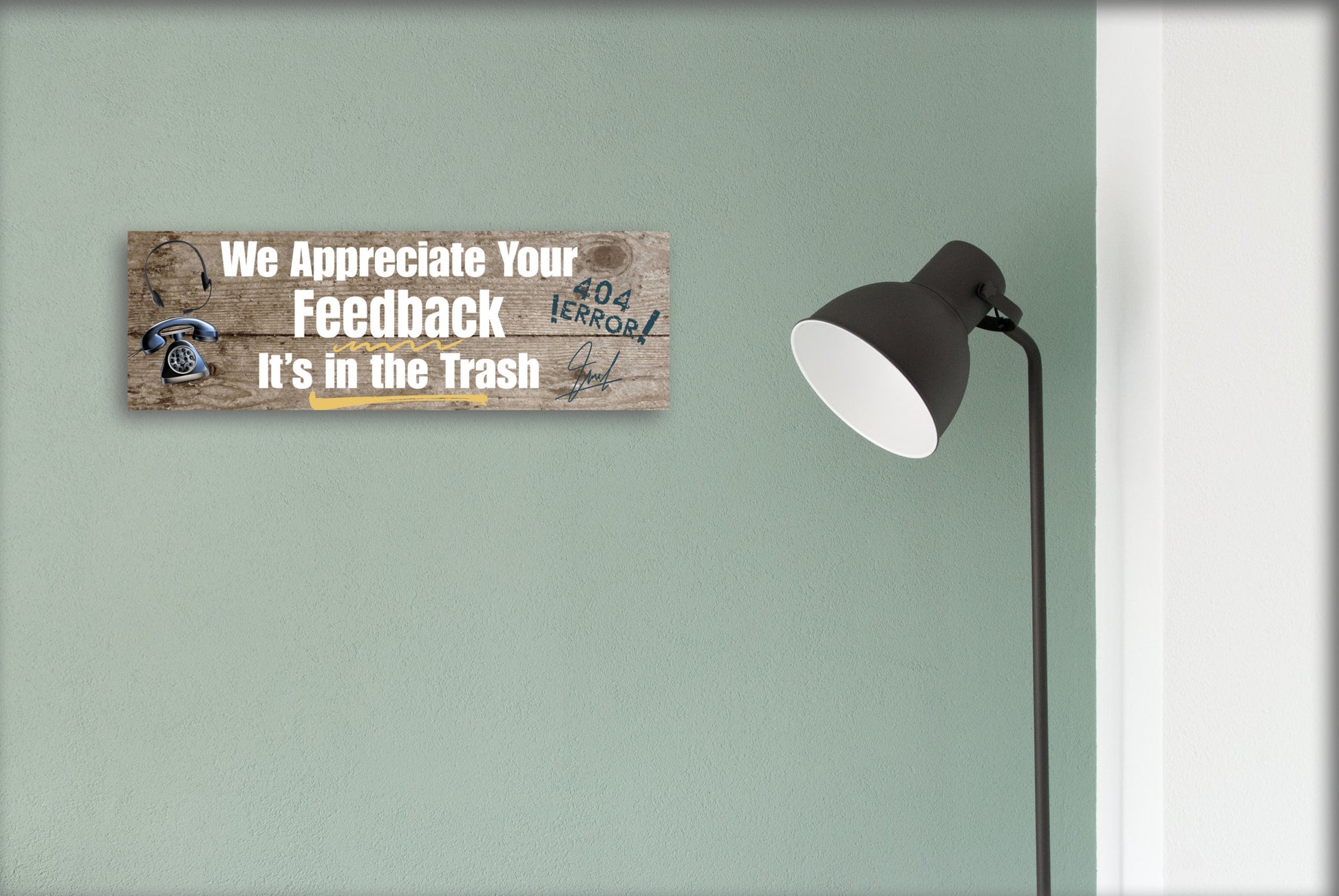 A rectangular wooden plaque featuring the sarcastic phrase "We Appreciate Your Feedback – It’s in the Trash" in bold white and red text on a dark vintage background with ornamental border details.