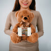 Soft plush teddy bear holding a sign that reads “Teddy Bears Tell the Truth – Not the Fake News,” a funny political and novelty gift.