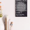 A wood-finish plaque with bold black text that reads “Accept What You Can’t Change” in capital letters, set in a clean and modern font.