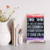 "Motivational wall plaque that reads ‘One Win Is All It Takes to Change Your Story Forever’ displayed above a desk workspace"