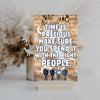 Emotional quote plaque reading “Time Is Precious” in soft script on neutral wood background, styled in a cozy living room setting with natural light.