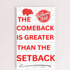 Motivational wall plaque with bold quote: “The Comeback Is Greater Than The Setback” in clean black-and-white print on wood, styled in a home office space.