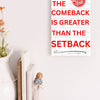 Motivational wall plaque with bold quote: “The Comeback Is Greater Than The Setback” in clean black-and-white print on wood, styled in a home office space.