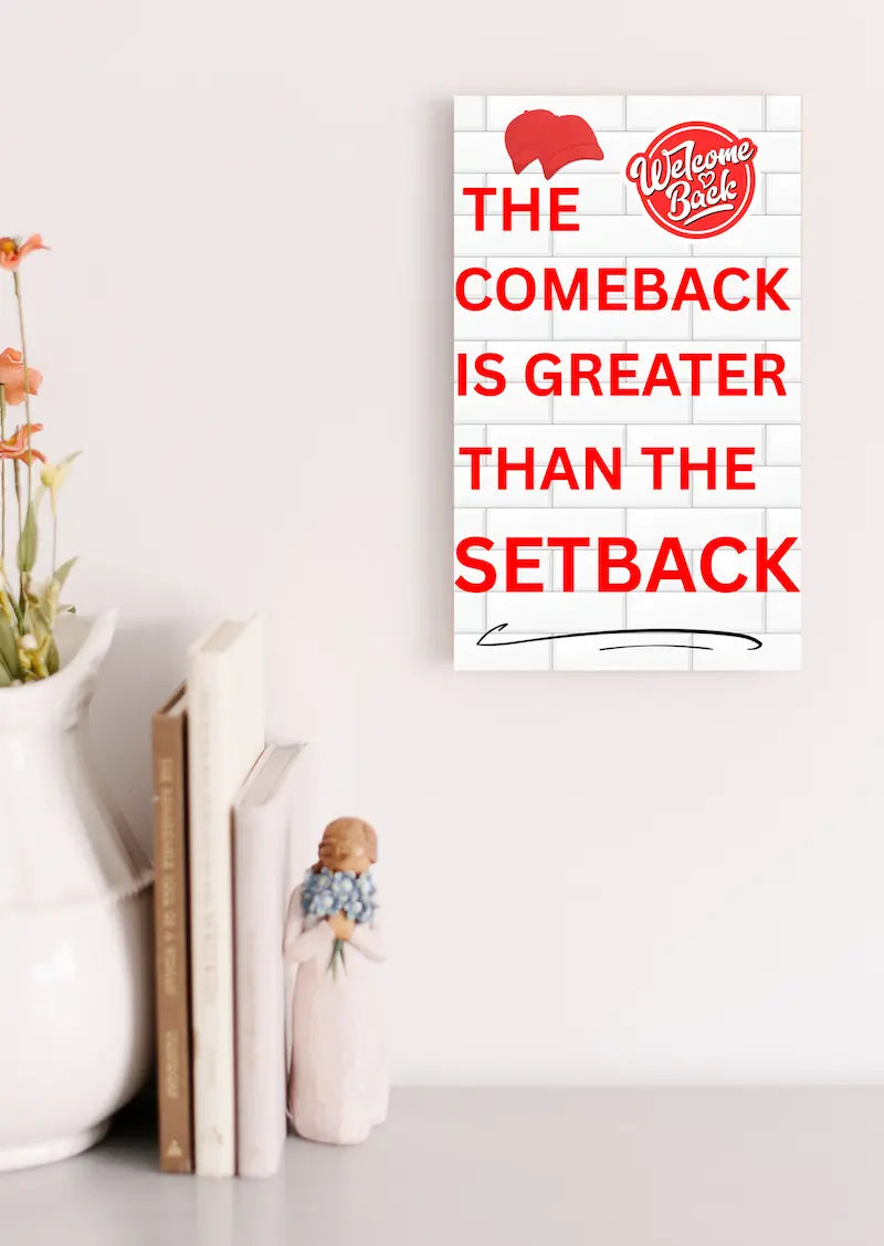 Motivational wall plaque with bold quote: “The Comeback Is Greater Than The Setback” in clean black-and-white print on wood, styled in a home office space.
