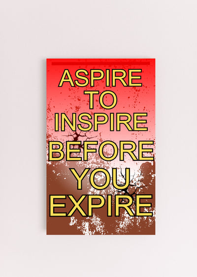 Modern inspirational plaque with the quote “Aspire to Inspire Before You Expire” in bold, artistic typography on wood, styled on a workspace wall.