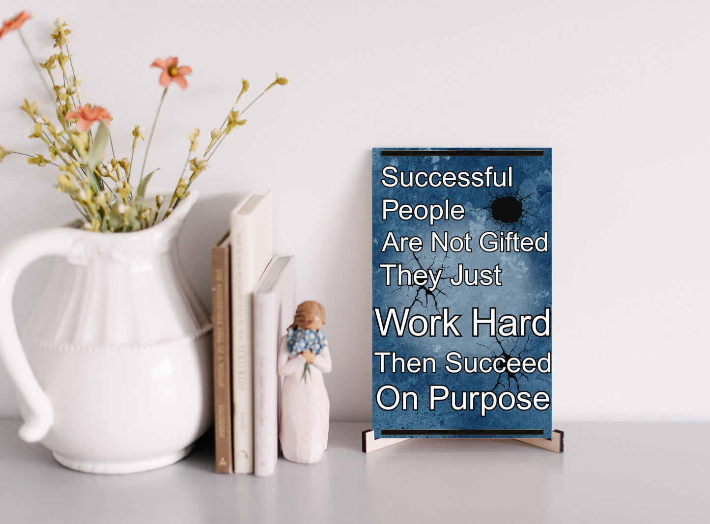 Inspirational quote plaque reading “Successful People Are Not Gifted, They Just Work Hard, Then Succeed On Purpose” in bold, modern typeface