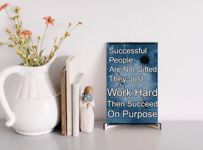 Inspirational quote plaque reading “Successful People Are Not Gifted, They Just Work Hard, Then Succeed On Purpose” in bold, modern typeface