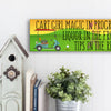 Wooden plaque with bold pink lettering reading “Cart Girl Magic In Progress” featuring cartoon-style golf cart, drink tray, and dollar signs—displayed outdoors.