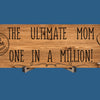 Wooden plaque reading “The Ultimate Mom” in bold script with floral accents and comic-style doodles, perfect for gifting or home décor.