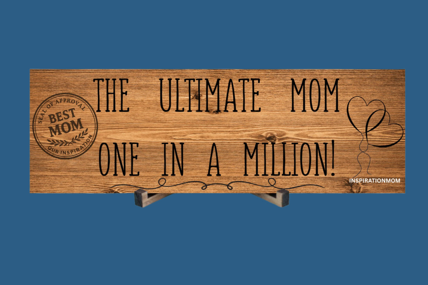 Wooden plaque reading “The Ultimate Mom” in bold script with floral accents and comic-style doodles, perfect for gifting or home décor.