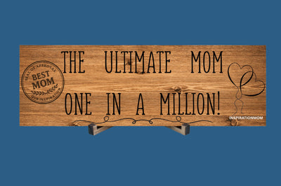 Wooden plaque reading “The Ultimate Mom” in bold script with floral accents and comic-style doodles, perfect for gifting or home décor.