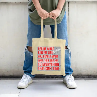 Natural cotton canvas tote bag printed with bold black text: “Decide what kind of life you really want,” accented by clean modern design elements.