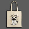 A beige canvas tote bag featuring a grumpy cartoon cat with the word “NOPE” in bold block letters.
