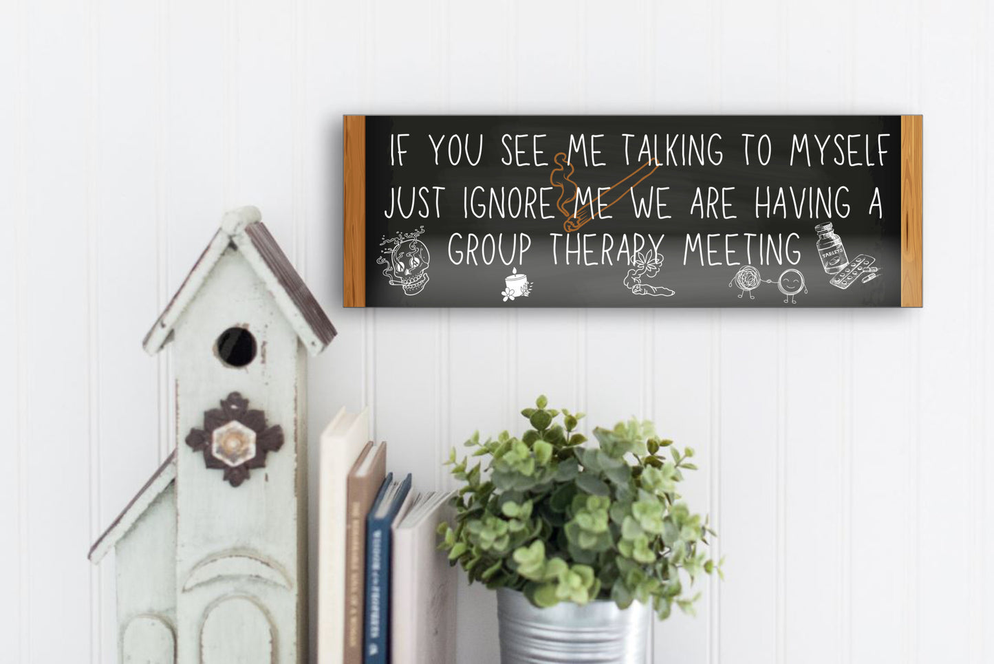 T-shirt with text: “If you see me talking to myself, just ignore me—we’re having a group therapy meeting.” Funny mental health quote tee in bold font.
