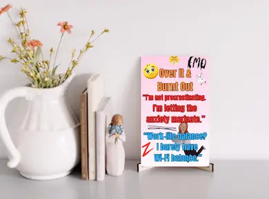 Wooden plaque with bold text “Over It & Burnt Out” in comic-style font, styled as sarcastic wall decor for modern burnout humor.