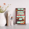 Wooden plaque with bold comic-style text: “My Love Language is Passive” displayed in a modern font on a rustic wood background.
