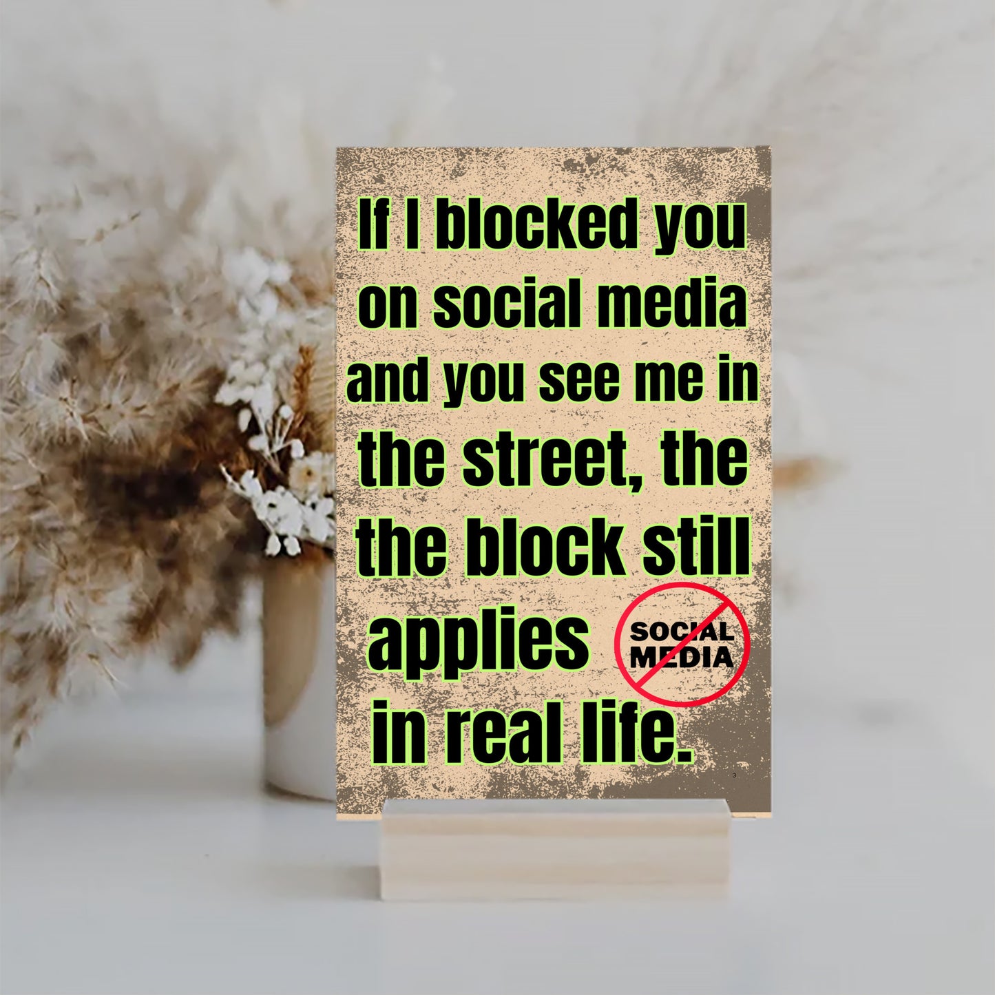 Wooden plaque with bold comic-style text: “If I blocked you on social media, you probably deserved it” displayed in sarcastic font.