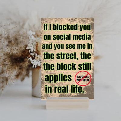 Wooden plaque with bold comic-style text: “If I blocked you on social media, you probably deserved it” displayed in sarcastic font.